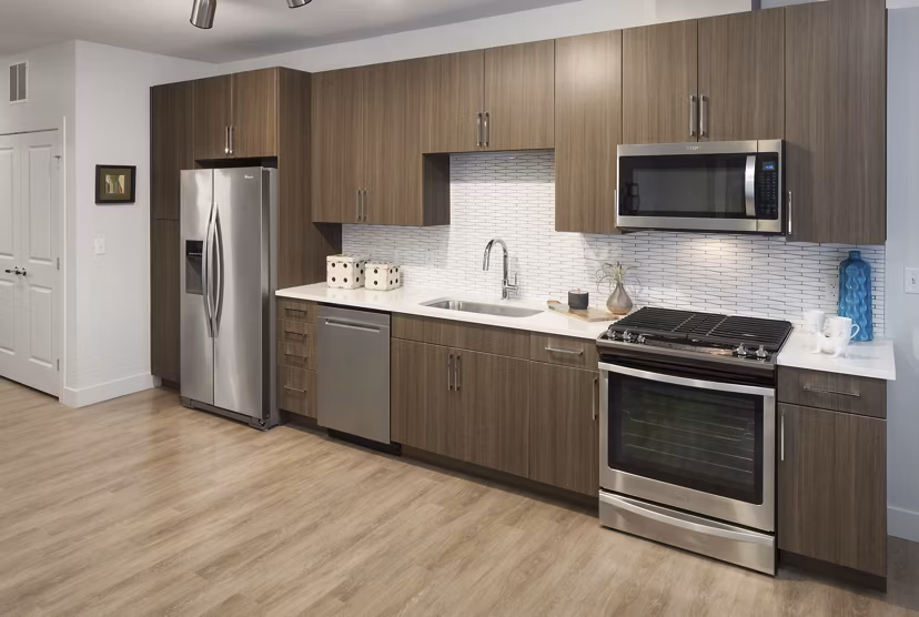 Modern kitchen with stainless steel appliances at Alexan LoHi Apartments, luxury living in a prime location