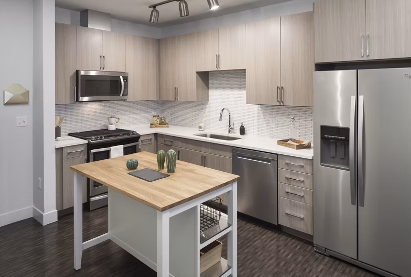 Modern kitchen featuring stainless steel appliances at Alexan LoHi Apartments