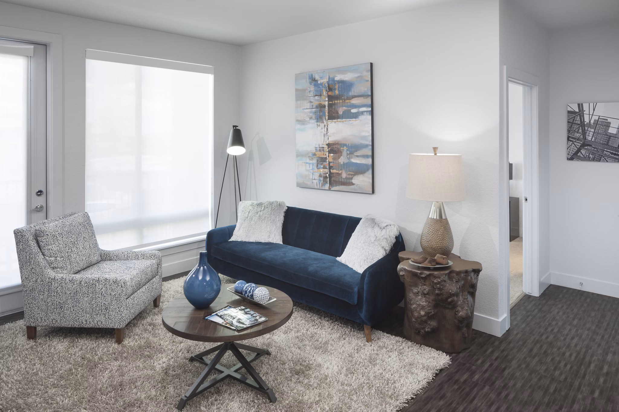 Living room with modern decor and natural light at Alexan LoHi Apartments, luxury apartments by Greystar in Denver
