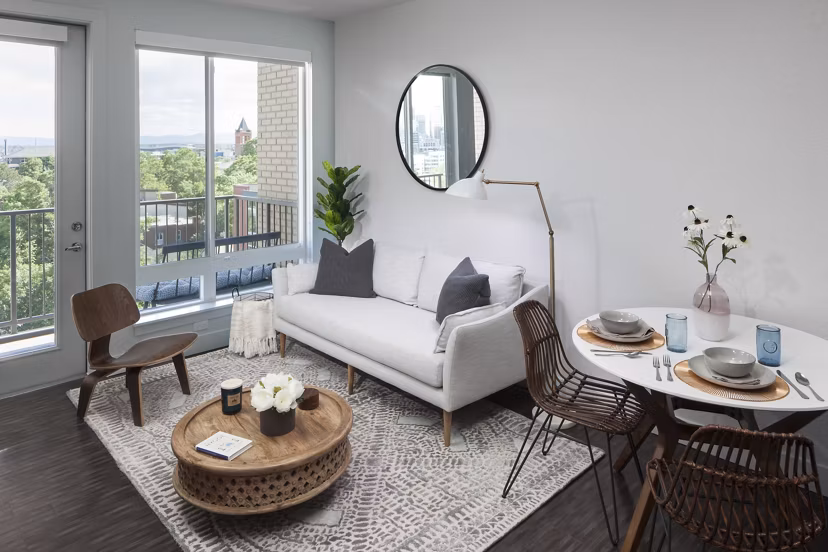 Stylish living room featuring modern decor and ample natural light at Alexan LoHi Apartments