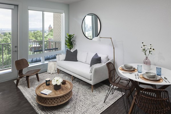 Stylish living room featuring modern decor and ample natural light at Alexan LoHi Apartments