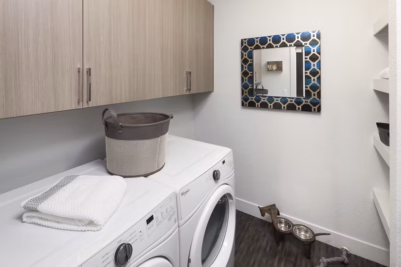 Spacious laundry room with modern appliances in Alexan LoHi Apartments, offering convenience for residents