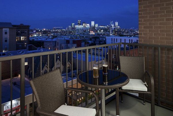 Outdoor patio with modern seating at Alexan LoHi Apartments, perfect for relaxing in luxury surroundings