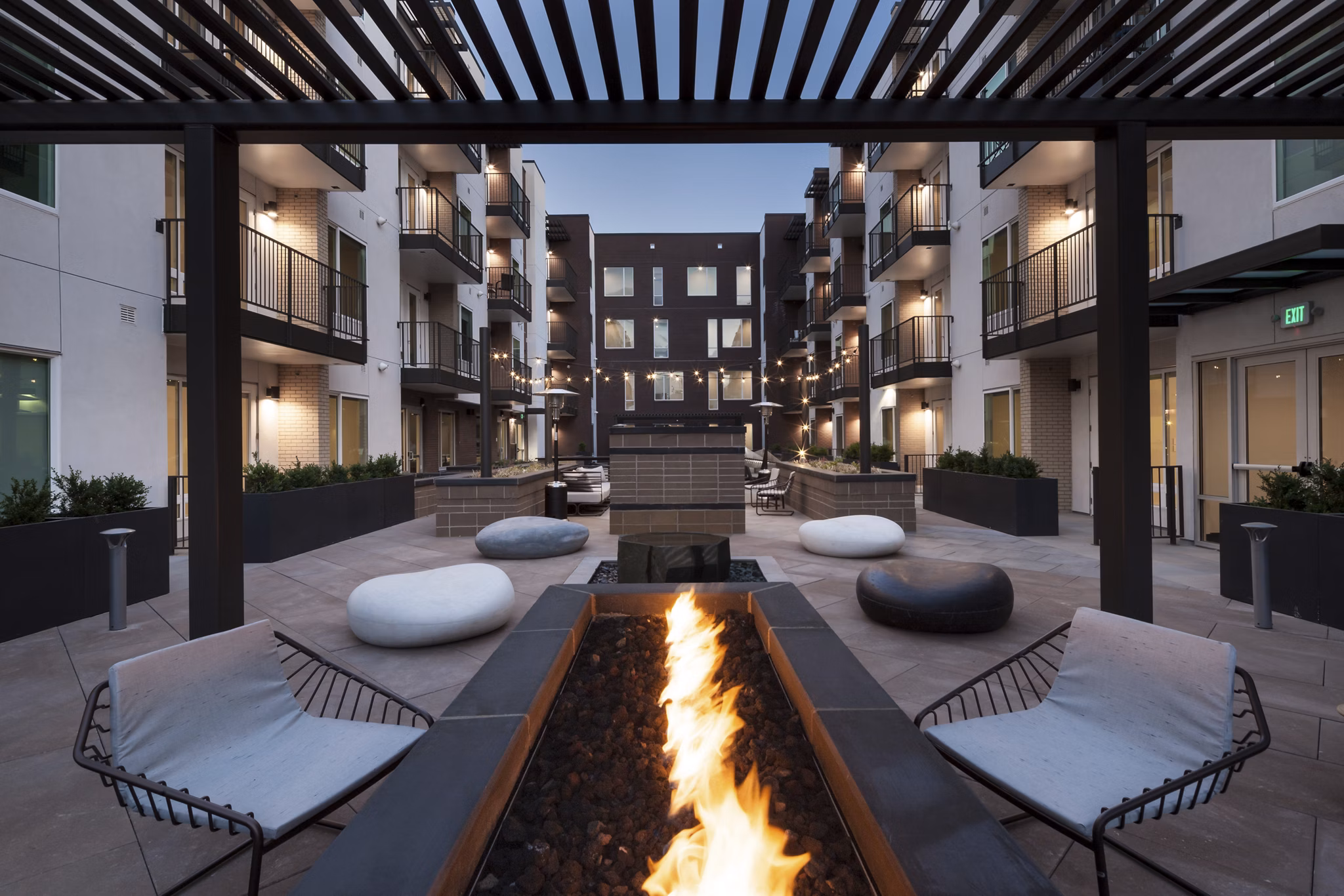 Cozy fire pit area with seating at Alexan LoHi Apartments, a luxury Greystar community in Denver