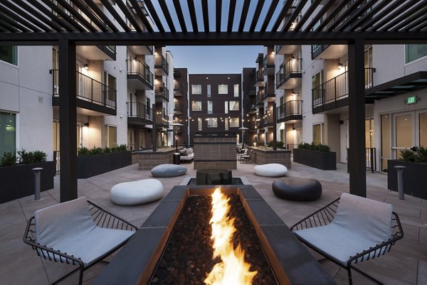 Cozy fire pit area with seating at Alexan LoHi Apartments, a luxury Greystar community in Denver