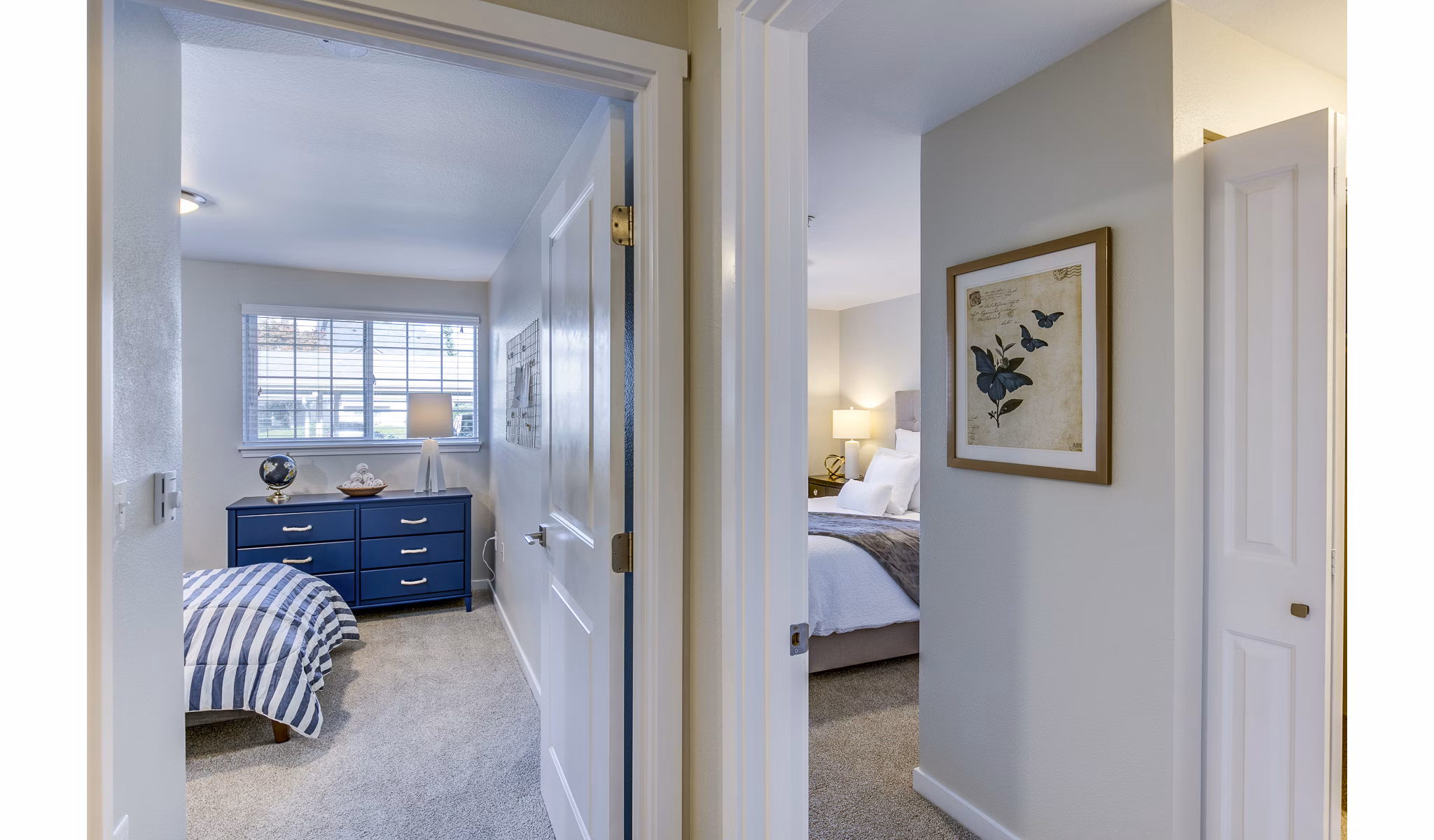 Modern hallway leading to a cozy bedroom at Callen Apartments with stylish lighting and neutral tones