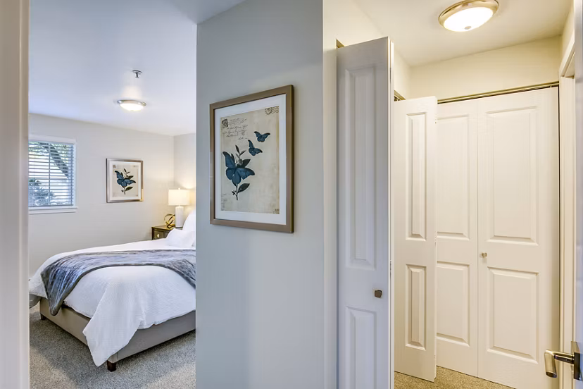 Modern hallway leading to a bright bedroom at Callen Apartments, featuring sleek design and contemporary decor