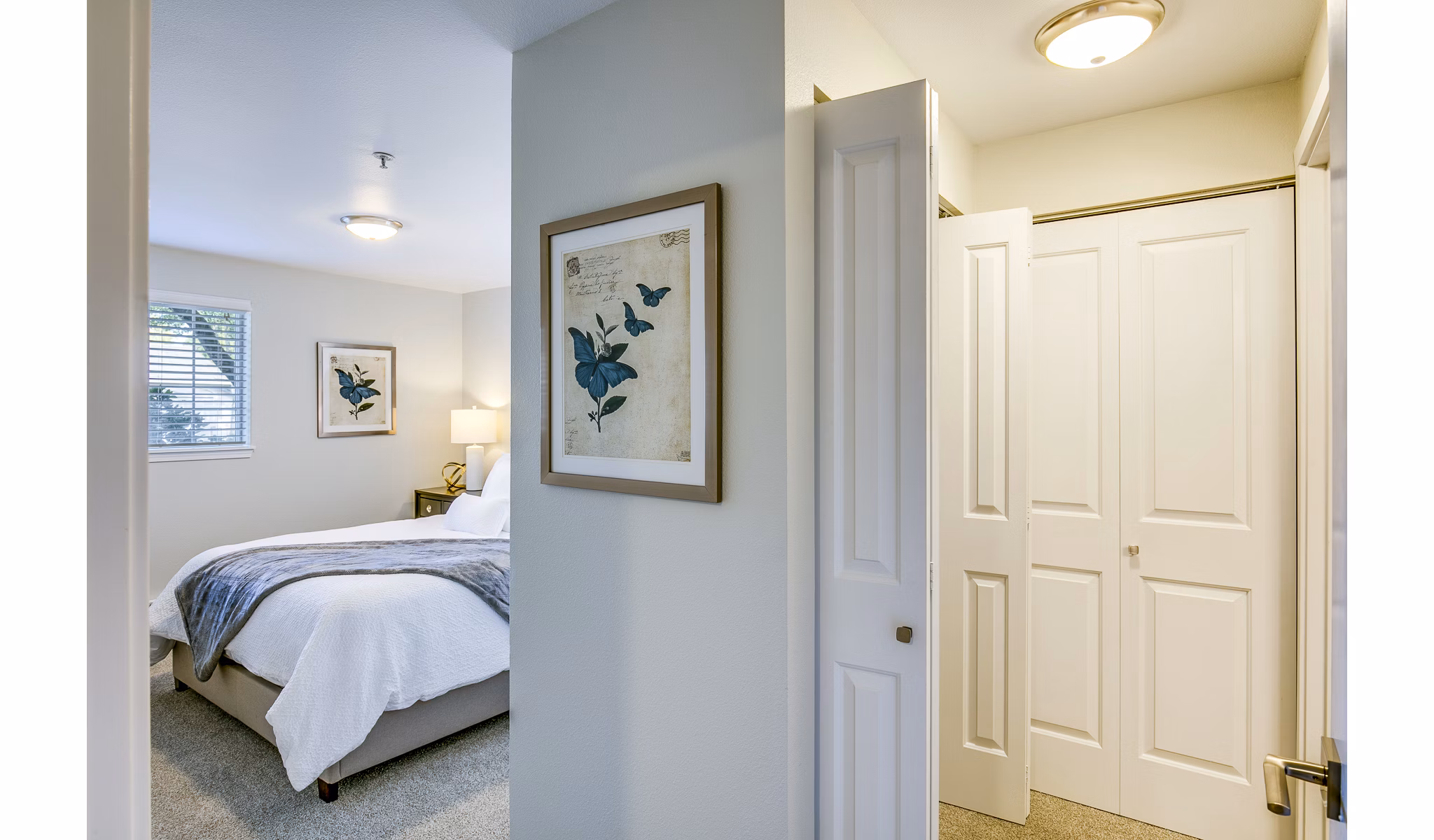 Modern hallway leading to a bright bedroom at Callen Apartments, featuring sleek design and contemporary decor