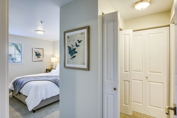 Modern hallway leading to a bright bedroom at Callen Apartments, featuring sleek design and contemporary decor