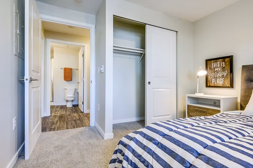 Cozy bedroom with modern furnishings at Callen Apartments, a Greystar luxury property
