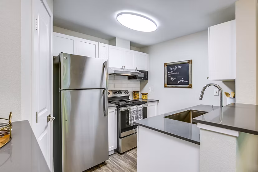 Modern kitchen with stainless steel appliances at Callen Apartments: luxury living space in Greystar community