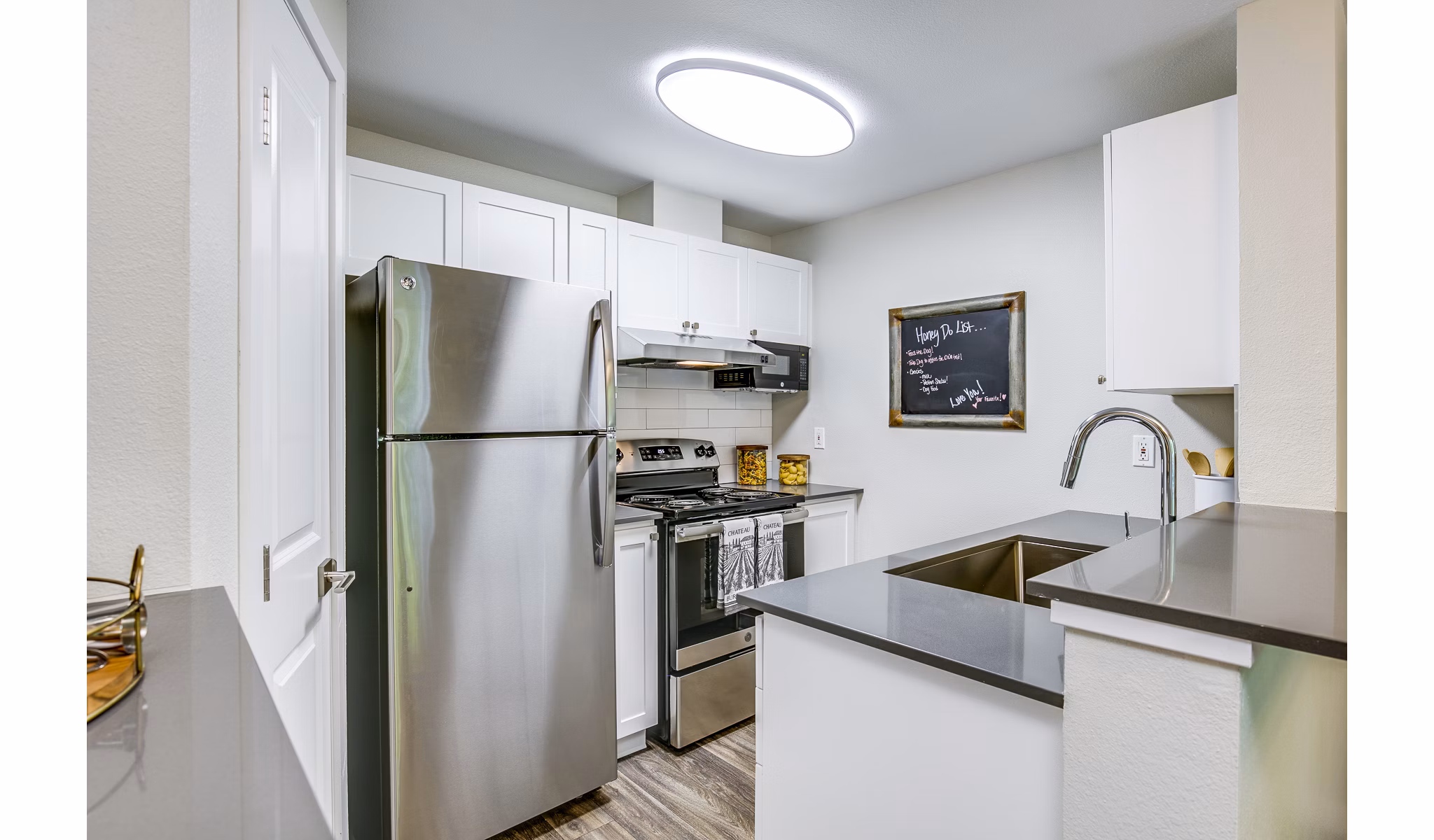 Modern kitchen with stainless steel appliances at Callen Apartments: luxury living space in Greystar community