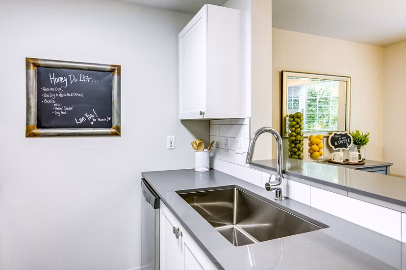 Callen Apartments: Modern kitchen with stainless steel appliances and granite countertops