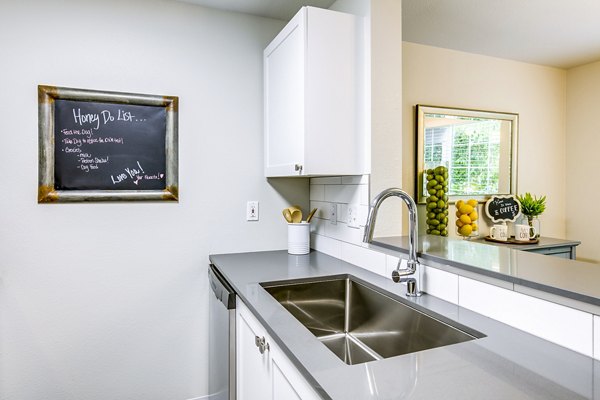 Callen Apartments: Modern kitchen with stainless steel appliances and granite countertops