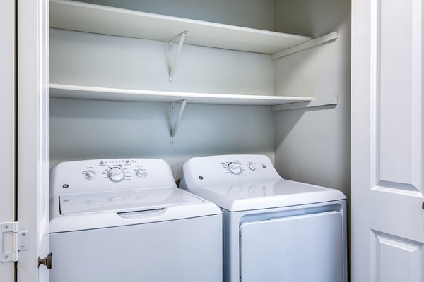 Laundry room with modern appliances at Callen Apartments in luxury Greystar community