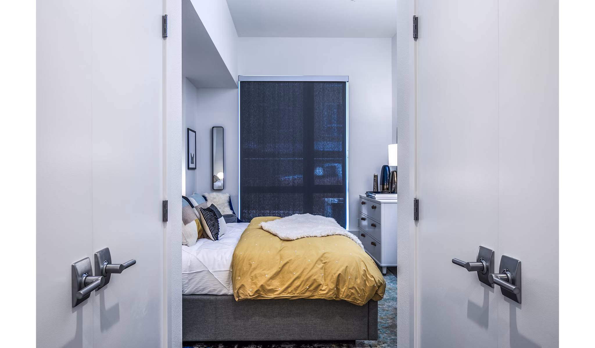 Elegant bedroom with modern decor and natural light at Hyde Square Apartments