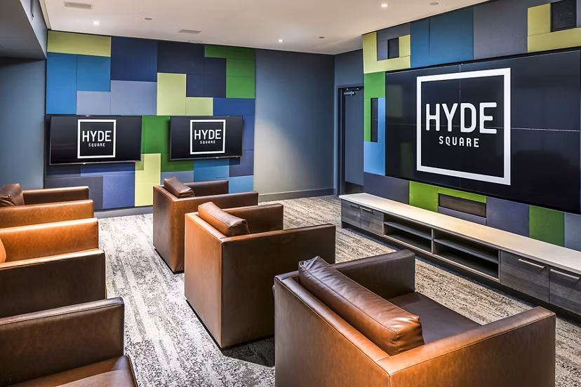 Clubhouse theater with plush seating and large screen at Hyde Square Apartments, perfect for entertainment and movie nights