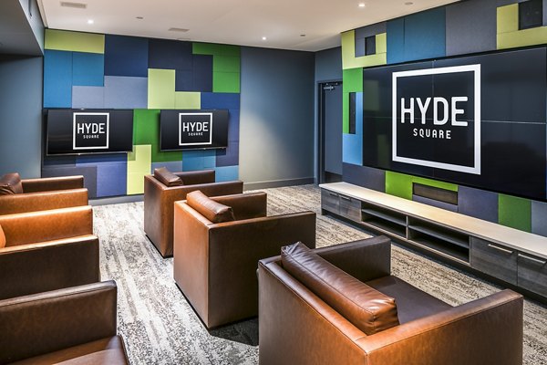 Clubhouse theater with plush seating and large screen at Hyde Square Apartments, perfect for entertainment and movie nights