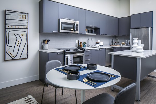 Dining room featuring modern decor and elegant lighting at Hyde Square Apartments