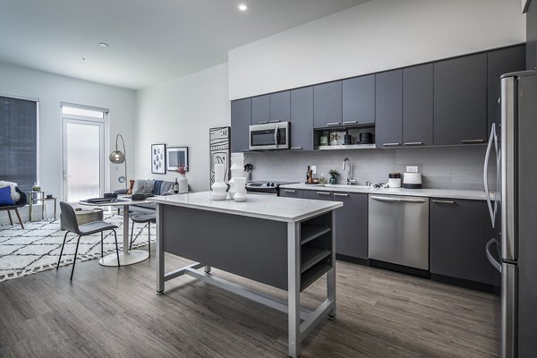 Modern kitchen featuring stainless steel appliances at Hyde Square Apartments