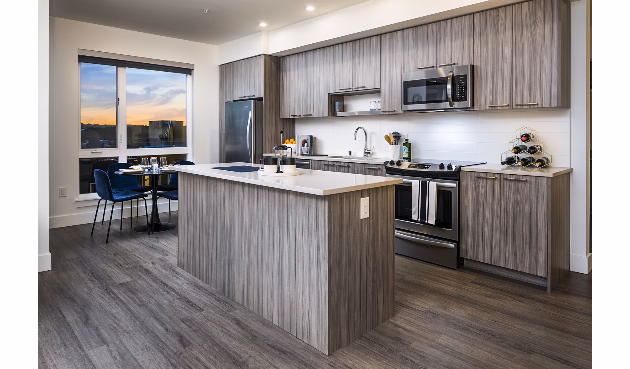 Modern kitchen with granite countertops and stainless steel appliances at Hyde Square Apartments
