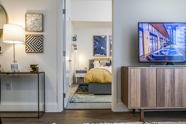 Modern living room/bedroom entrance with stylish decor in Hyde Square Apartments, luxury living in central location