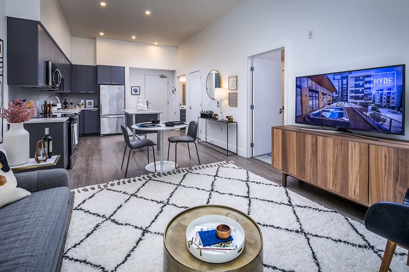 Welcoming living room with contemporary decor and ample natural light at Hyde Square Apartments