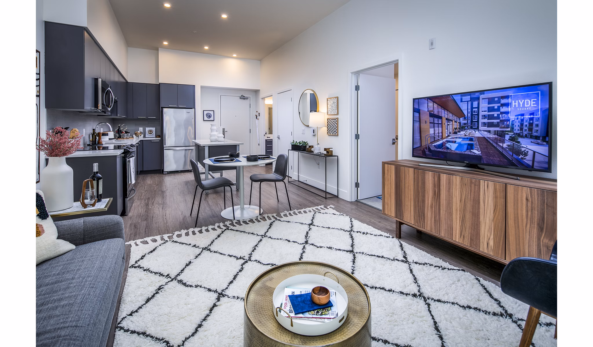Welcoming living room with contemporary decor and ample natural light at Hyde Square Apartments