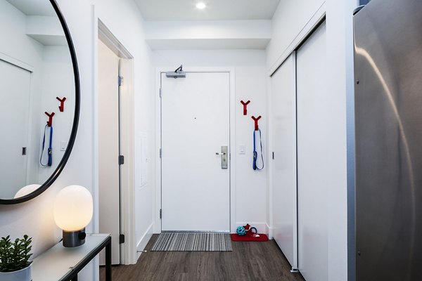 Entrance hallway with modern decor at Hyde Square Apartments, featuring sleek design elements and ample lighting for a welcoming atmosphere