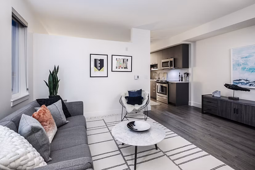 Living room with modern decor and large windows at Hyde Square Apartments, luxury living in the heart of the city