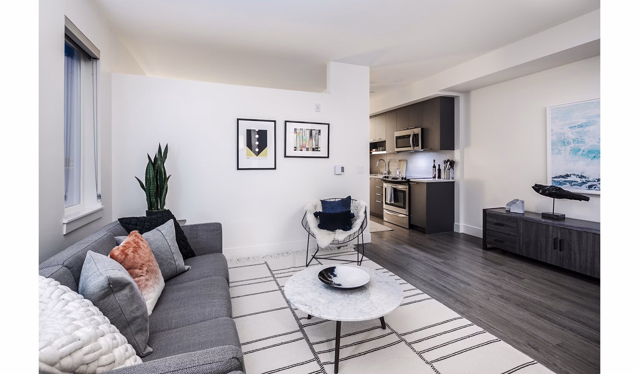 Living room with modern decor and large windows at Hyde Square Apartments, luxury living in the heart of the city