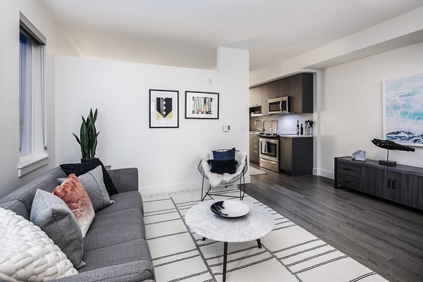 Living room with modern decor and large windows at Hyde Square Apartments, luxury living in the heart of the city