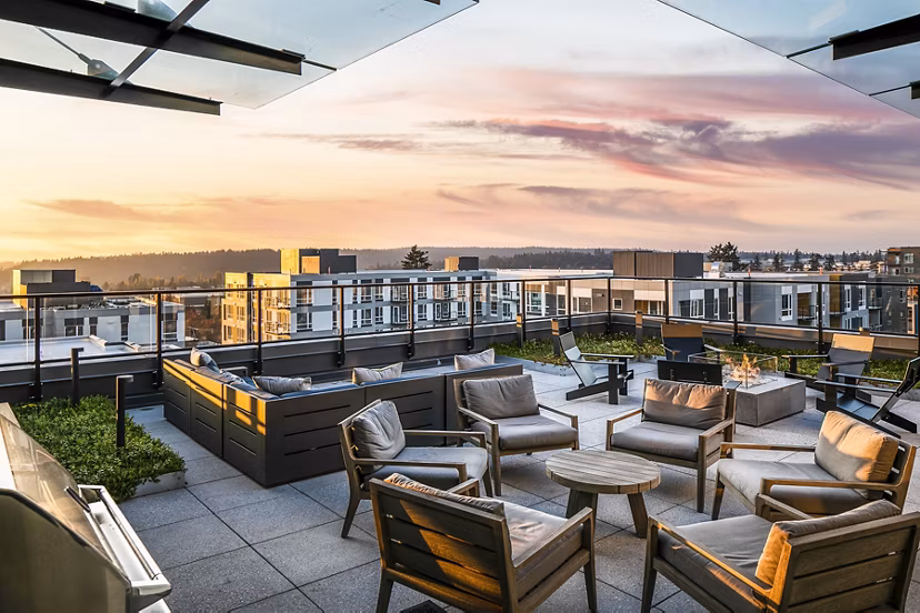 Cozy patio with outdoor seating at Hyde Square Apartments with views of the surrounding greenery