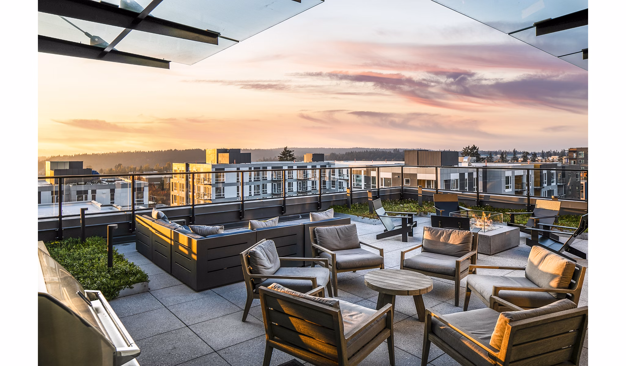 Cozy patio with outdoor seating at Hyde Square Apartments with views of the surrounding greenery