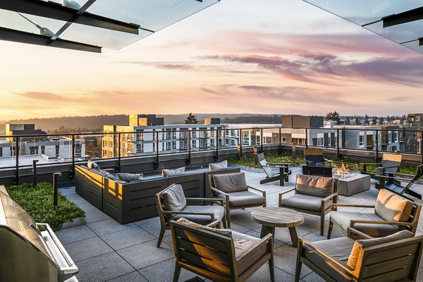 Cozy patio with outdoor seating at Hyde Square Apartments with views of the surrounding greenery