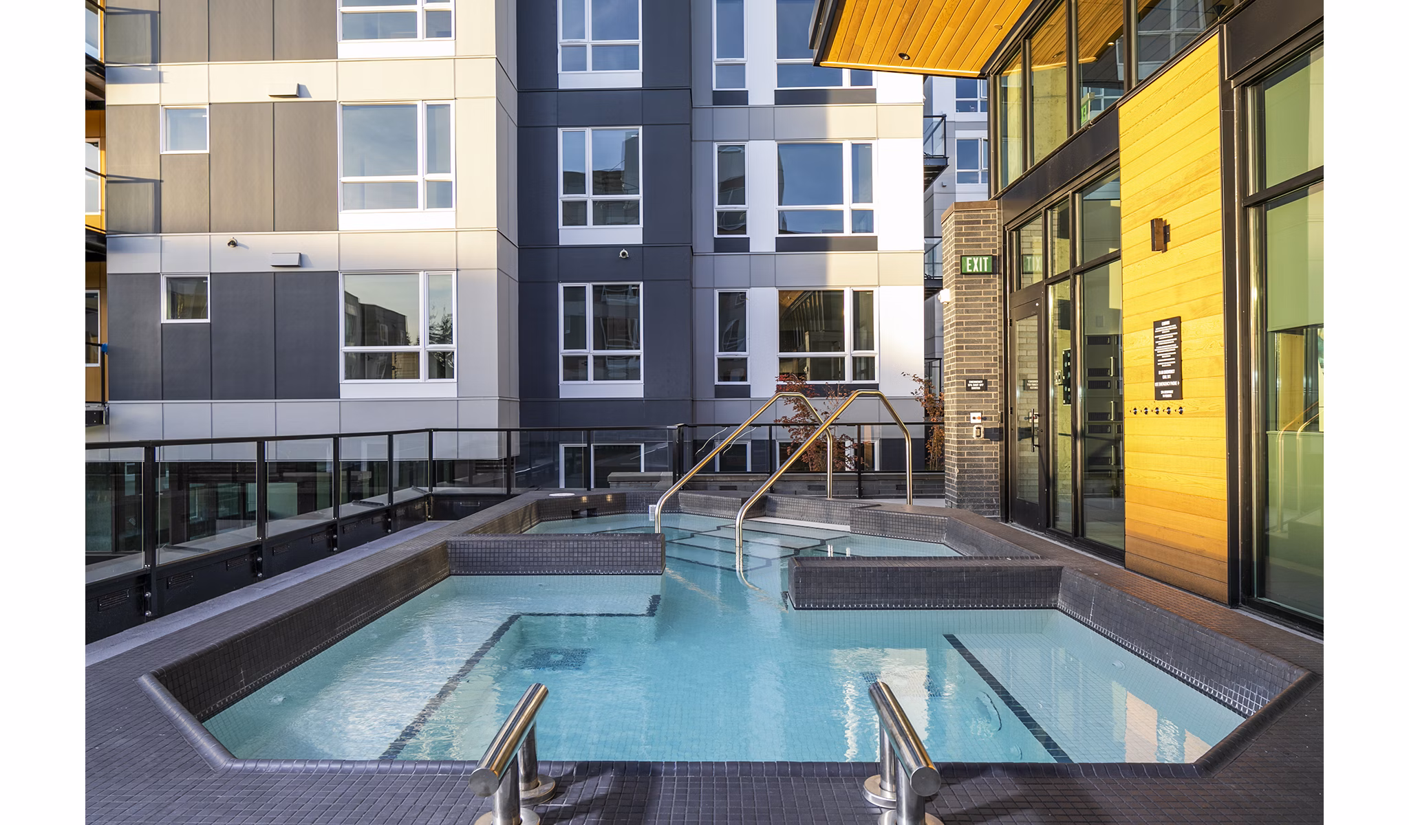 Outdoor pool with stylish seating at Hyde Square Apartments