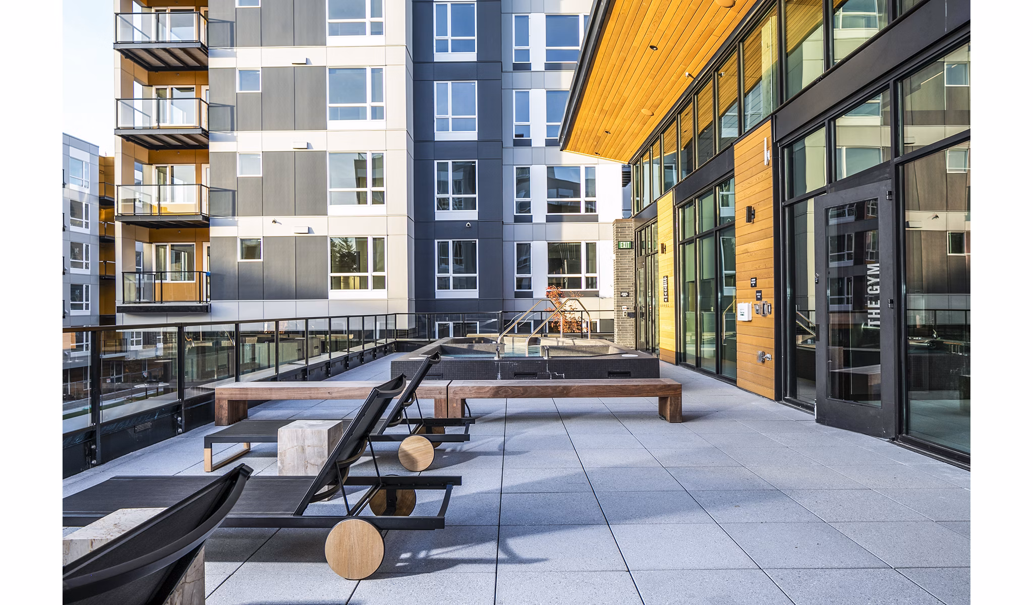 Luxurious pool deck with stylish patio furniture at Hyde Square Apartments, perfect for relaxation and leisure activities