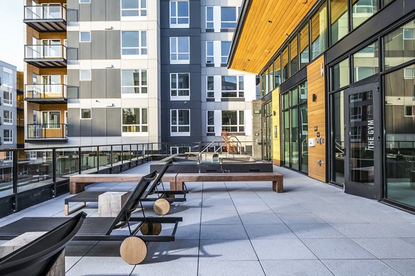 Luxurious pool deck with stylish patio furniture at Hyde Square Apartments, perfect for relaxation and leisure activities