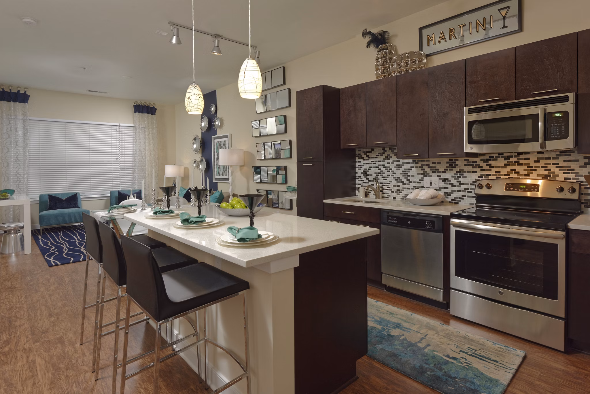 Modern kitchen featuring stainless steel appliances and granite countertops in Station 650 Apartments