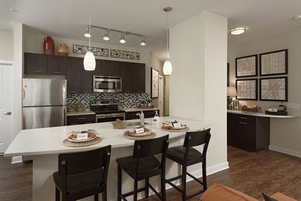 Modern kitchen with sleek cabinetry and stainless steel appliances at Station 650 Apartments