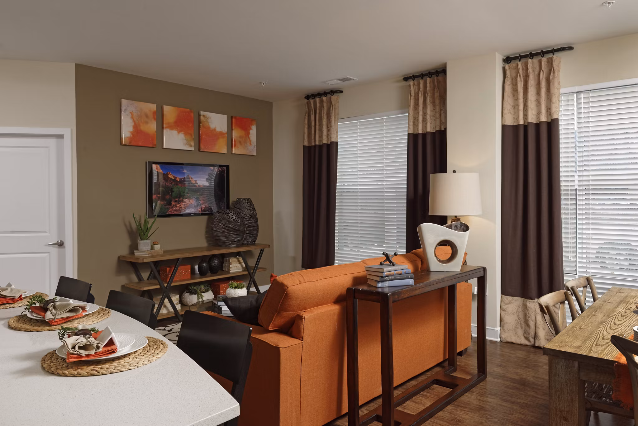Spacious living room featuring modern decor and large windows in Station 650 Apartments