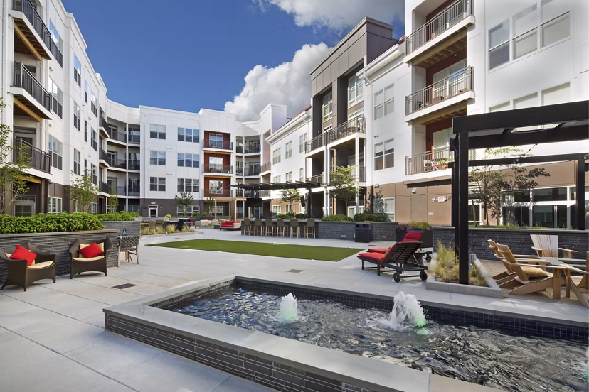 Outdoor recreation area at Station 650 Apartments with landscaped courtyard, seating, and pathways for relaxation and leisure activities