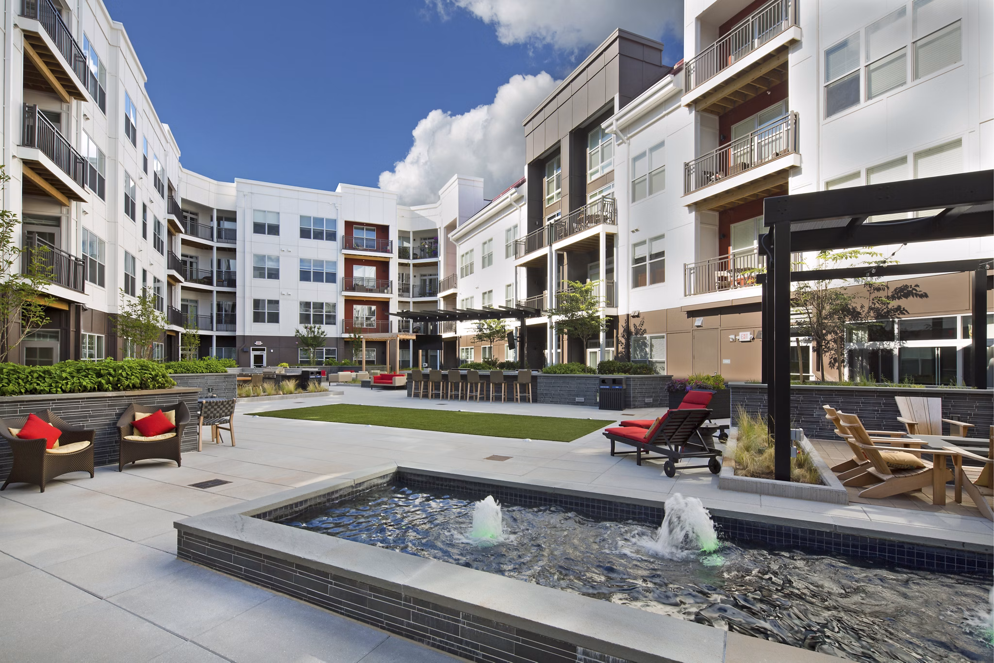 Outdoor recreation area at Station 650 Apartments with landscaped courtyard, seating, and pathways for relaxation and leisure activities