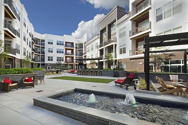 Outdoor recreation area at Station 650 Apartments with landscaped courtyard, seating, and pathways for relaxation and leisure activities