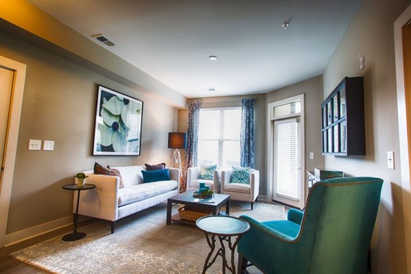 Modern living room with plush seating and large windows in Marlowe Lake Boone luxury apartments
