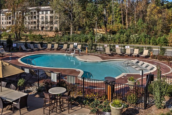 Outdoor infinity pool with serene views at Marlowe Lake Boone Apartments