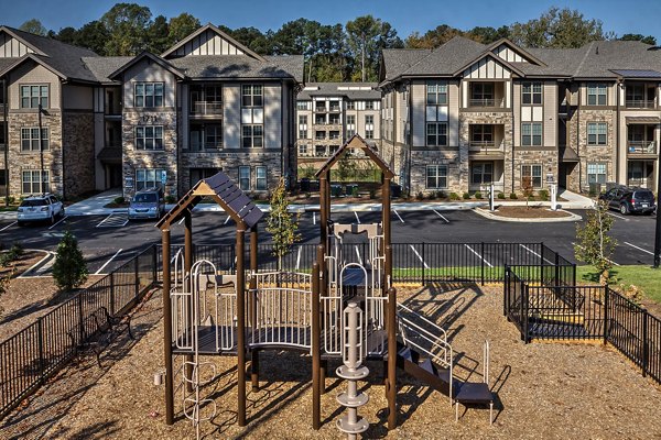 Outdoor playground with modern equipment at Marlowe Lake Boone Apartments