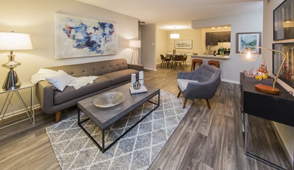 Spacious living room with modern decor at Lakeside Mill Apartments, featuring comfortable seating and natural light