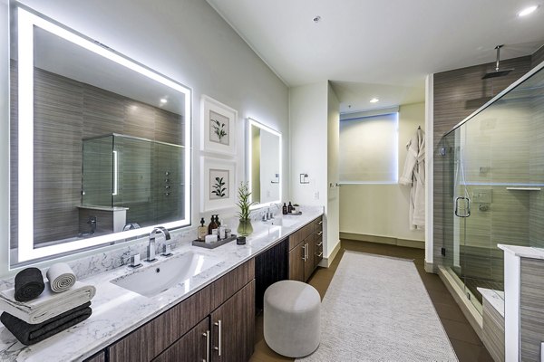 Modern bathroom with sleek design and spacious shower at Latitude Med Center Apartments