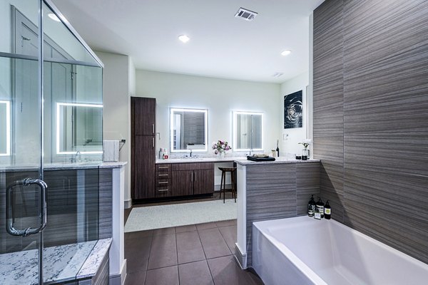 Bathroom featuring modern fixtures and marble countertops at Latitude Med Center Apartments